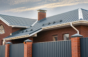 house under construction with a gutter system on a metal roof